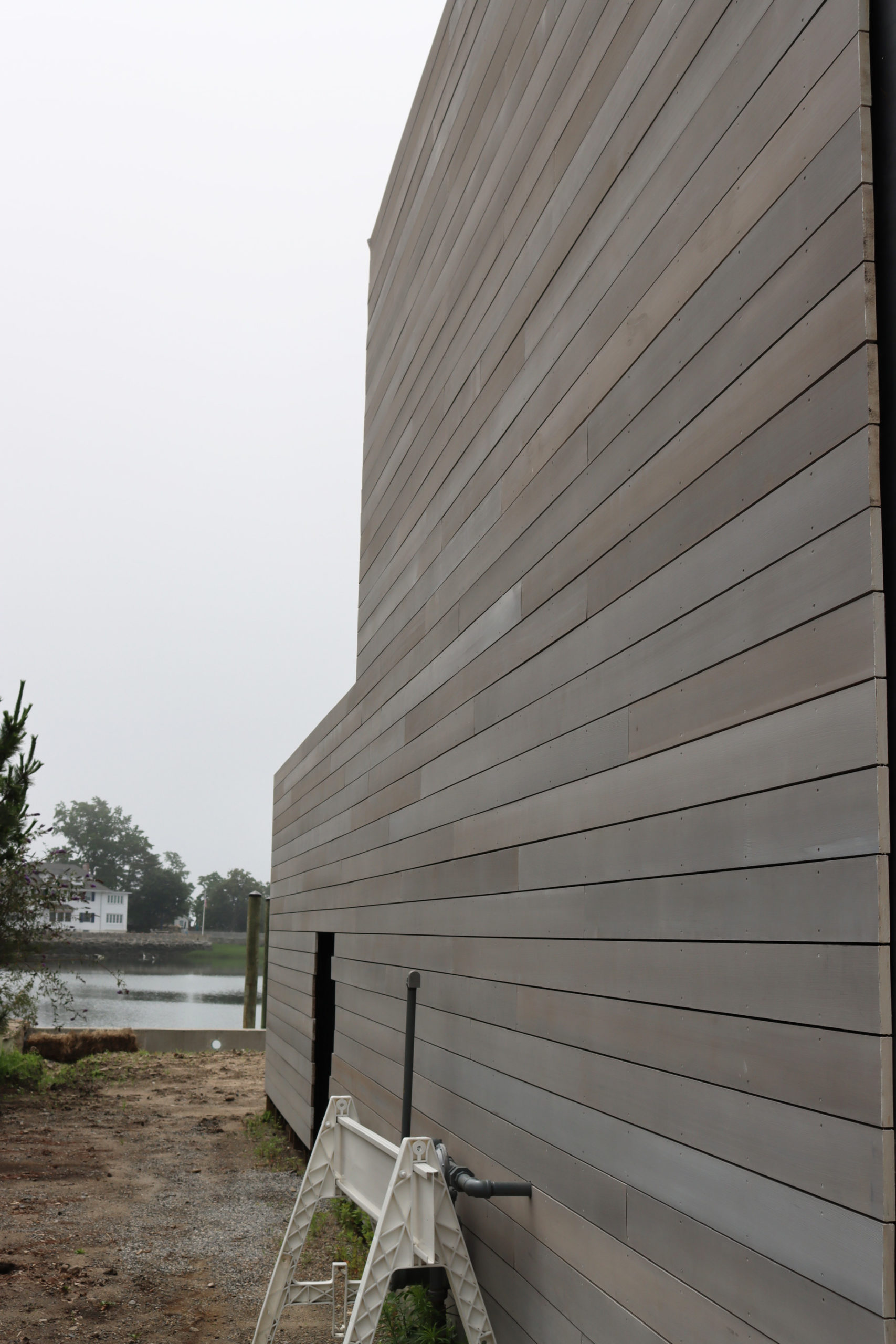 Greenwich Cove Residence featuring WILLIWAW weathered Alaskan Yellow Cedar Exterior Siding, Interior Cladding, and Roof Cladding