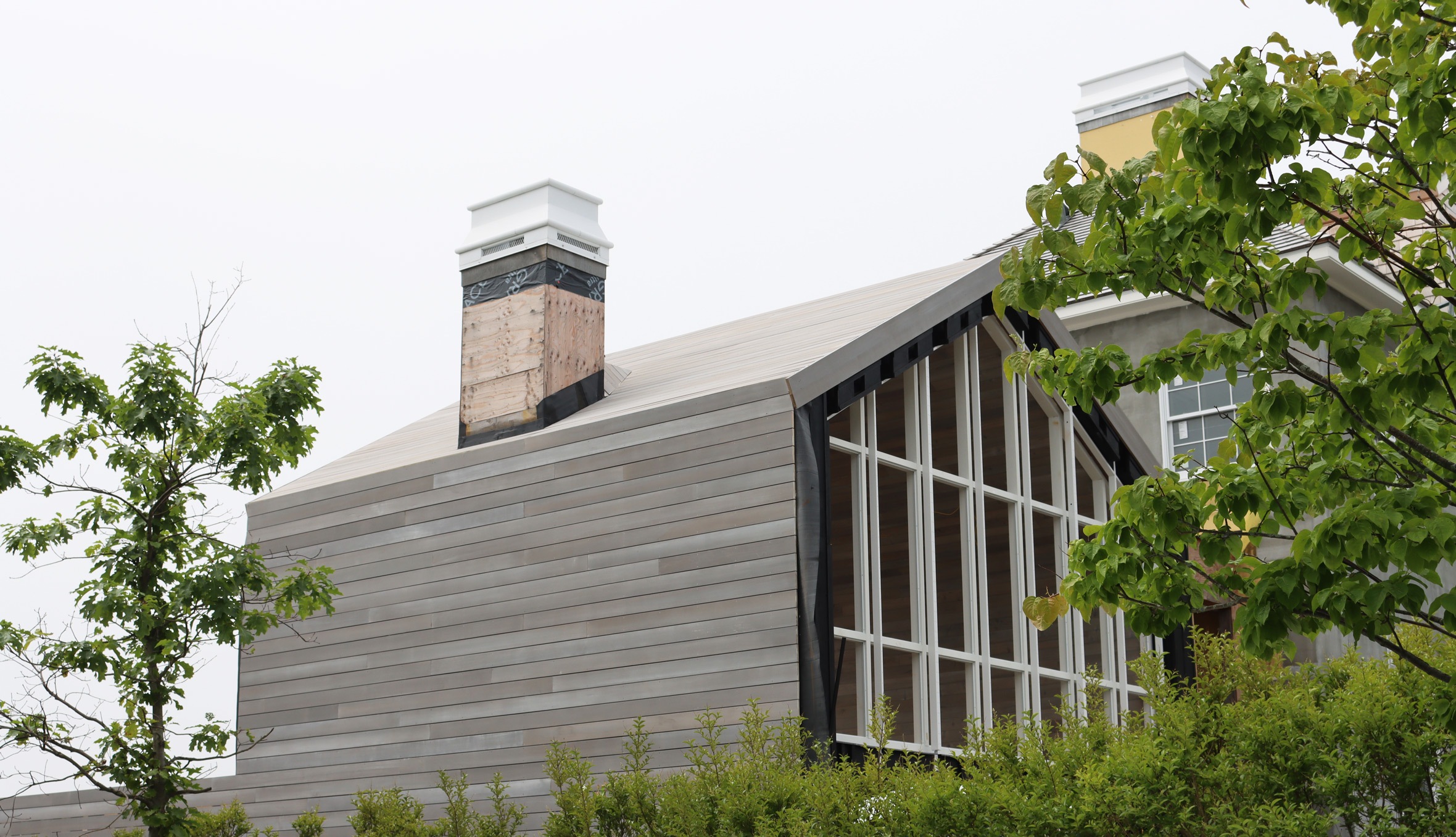 Greenwich Cove Residence featuring WILLIWAW weathered Alaskan Yellow Cedar Exterior Siding, Interior Cladding, and Roof Cladding